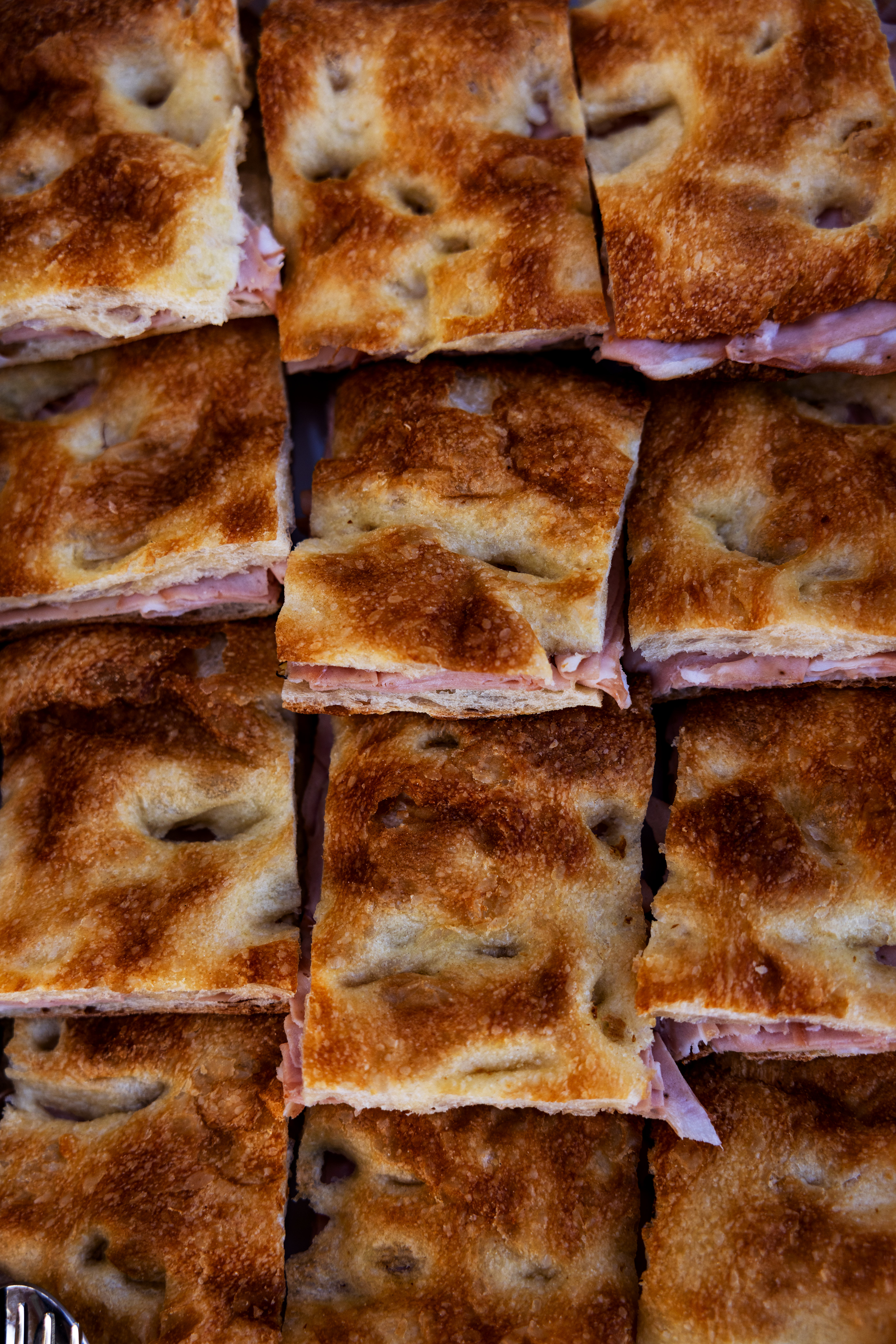 Catered Italian focaccia sandwiches with meat and cheese Focaccia sandwiches with meat and cheese at a catering event by Roscioli